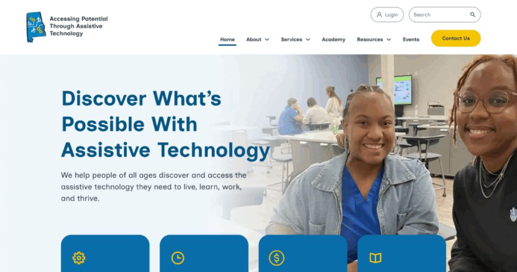 Home page of website with two women smiling at a table in a classroom setting; the screen displays the text "Discover What’s Possible With Assistive Technology" and navigation menu options at the top.